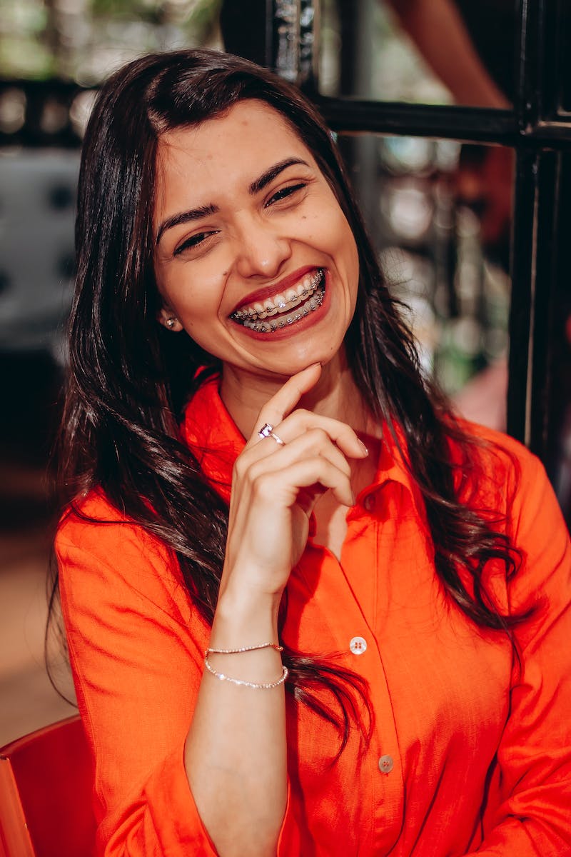 Woman in Orange Top Smiling